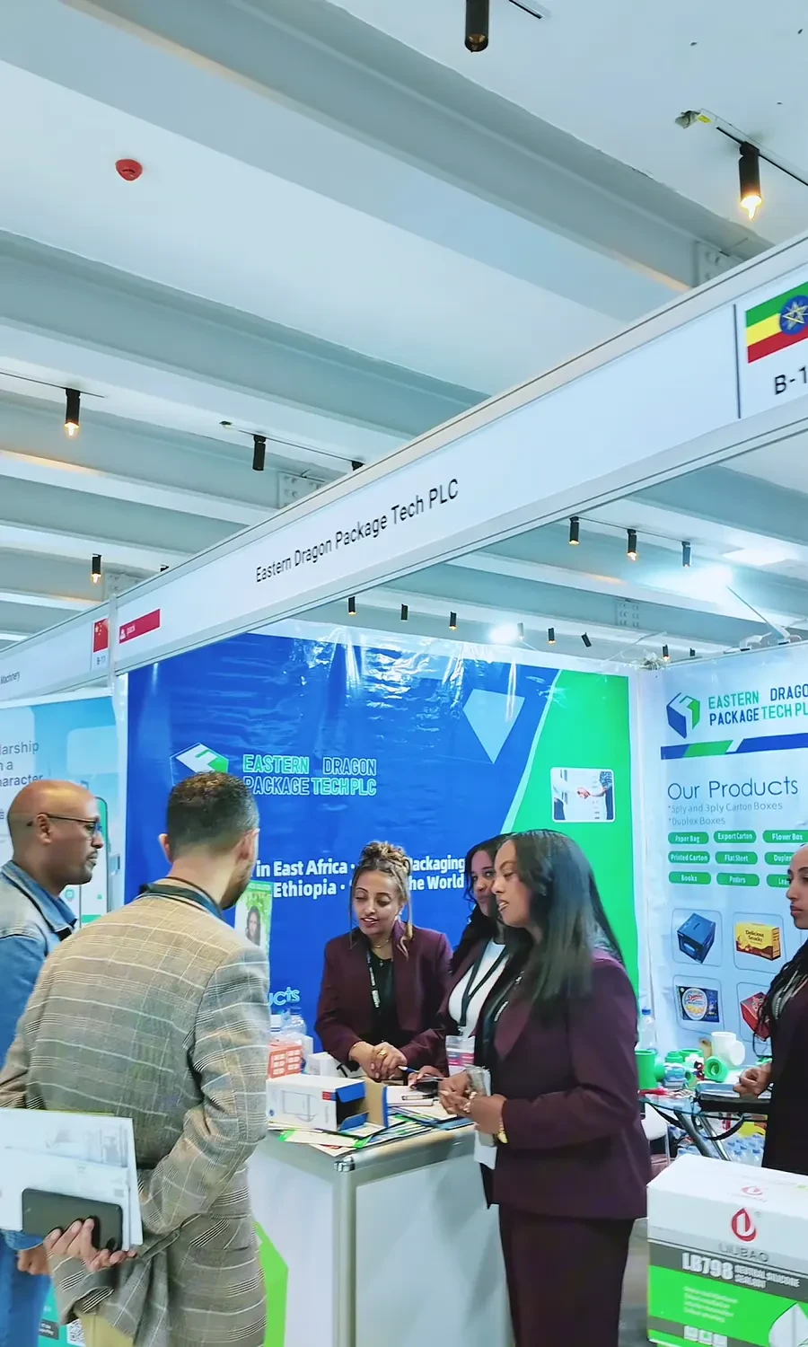 Eastern Dragon staff speak with visitors at the company exhibition booth in Addis Ababa.