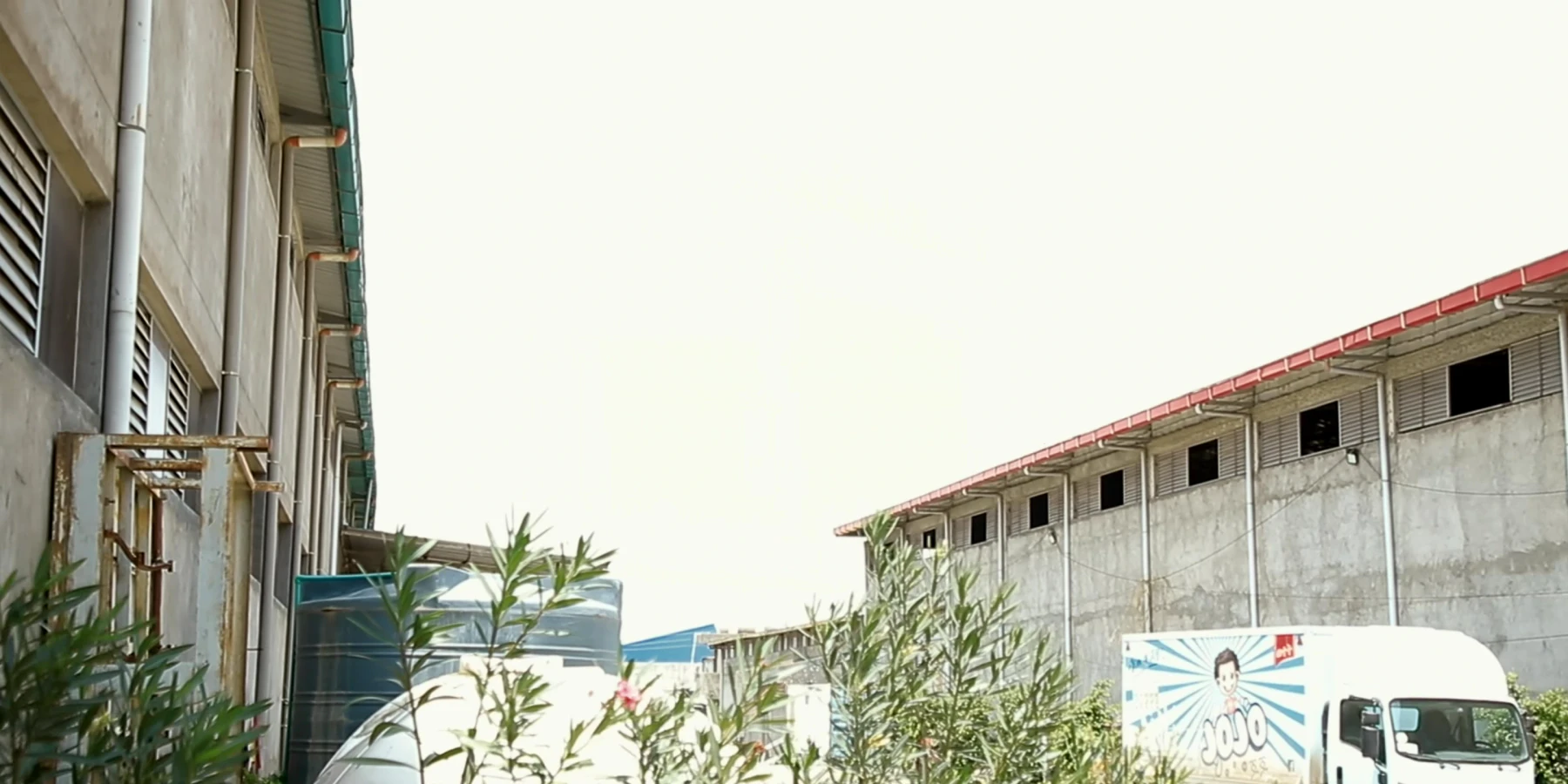 Exterior of the Eastern Dragon factory with a delivery truck beside the building.