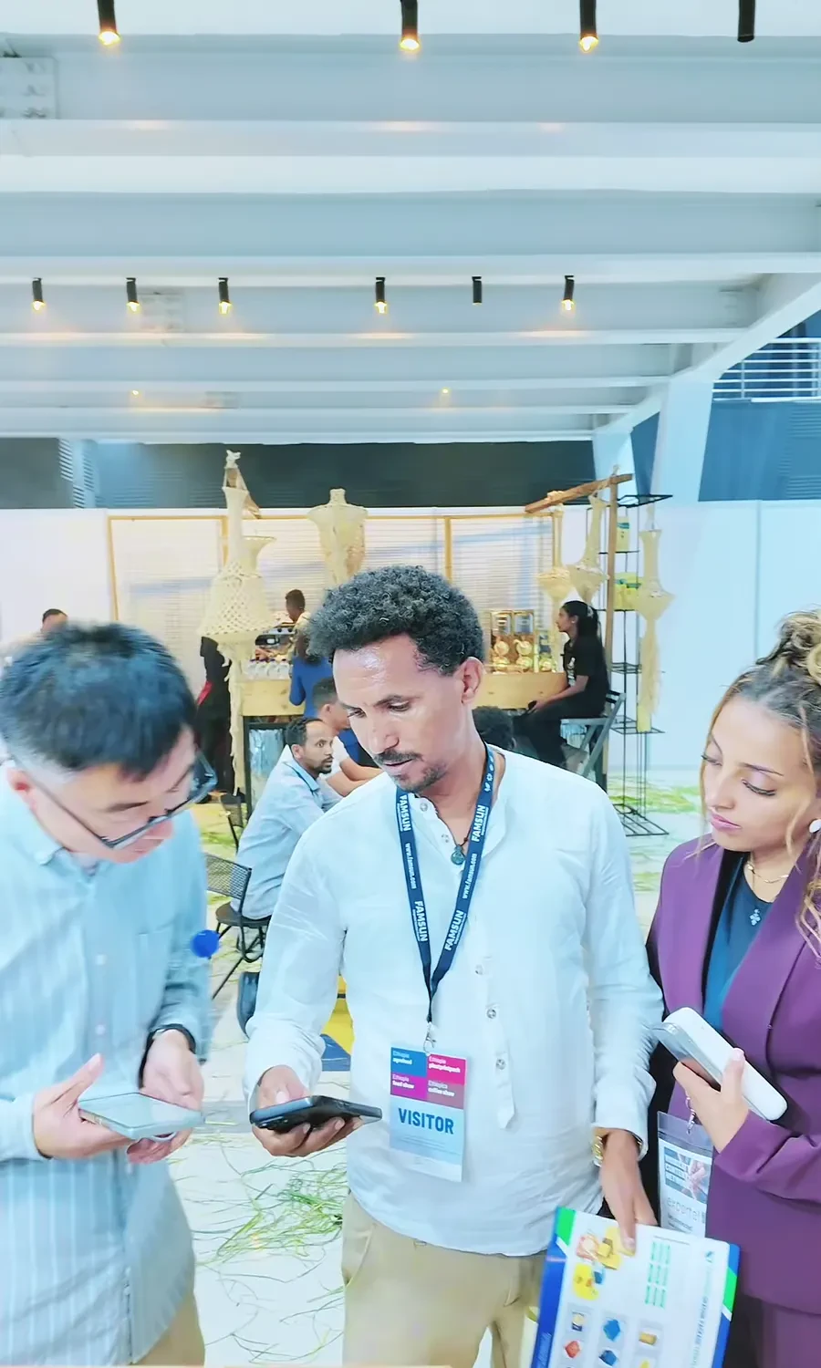 Eastern Dragon representatives discuss packaging with visitors around the display table.