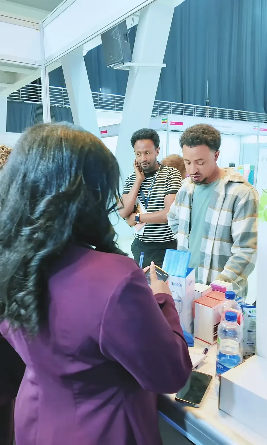 An Eastern Dragon representative explains a product sample to a visitor.